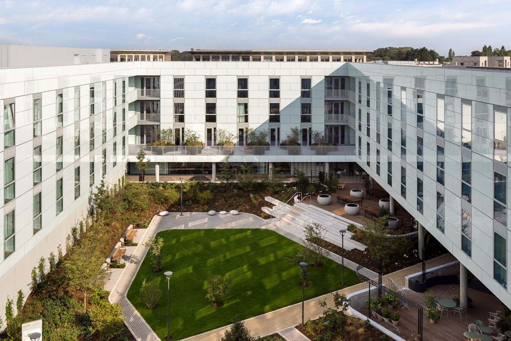 An exterior courtyard view and apartment at Turing Locke.